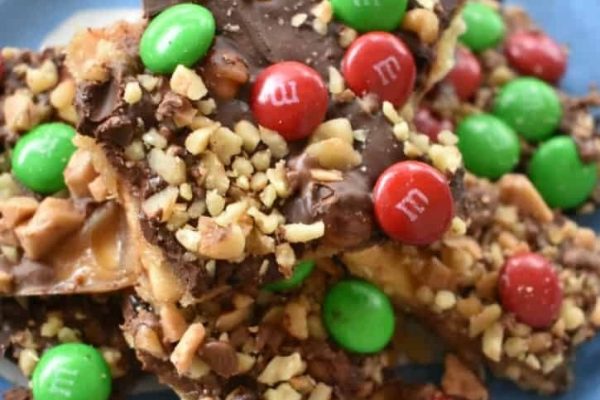 A plate of m & m's candy bars on a blue plate.