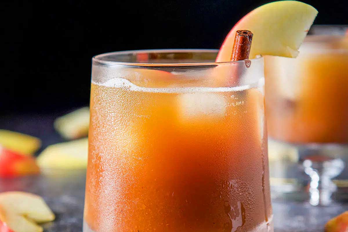 A refreshing fall cocktail - apple cider served with a crisp slice of apple.