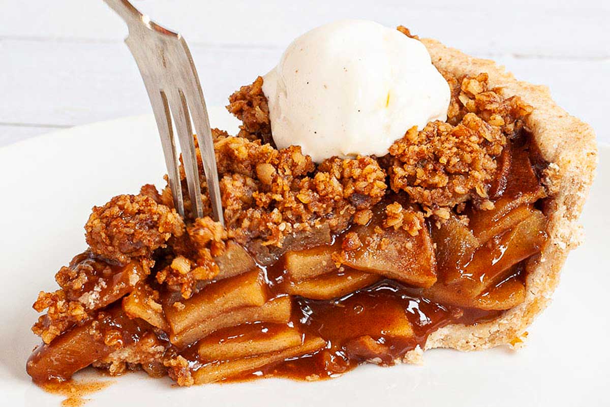A slice of vegan apple pie on a plate.