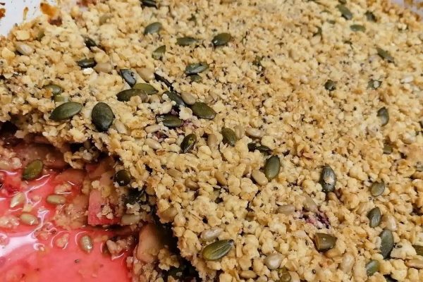 A dish with berries and seeds in it.
