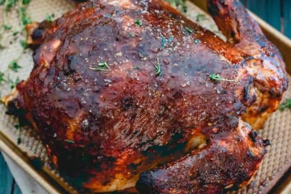 A roasted chicken on a baking sheet.