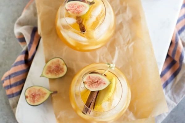 Two glasses of sangria with figs and cinnamon, perfect for a cozy evening.