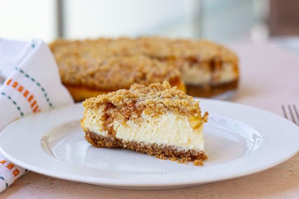 A slice of cheesecake on a plate with a napkin.