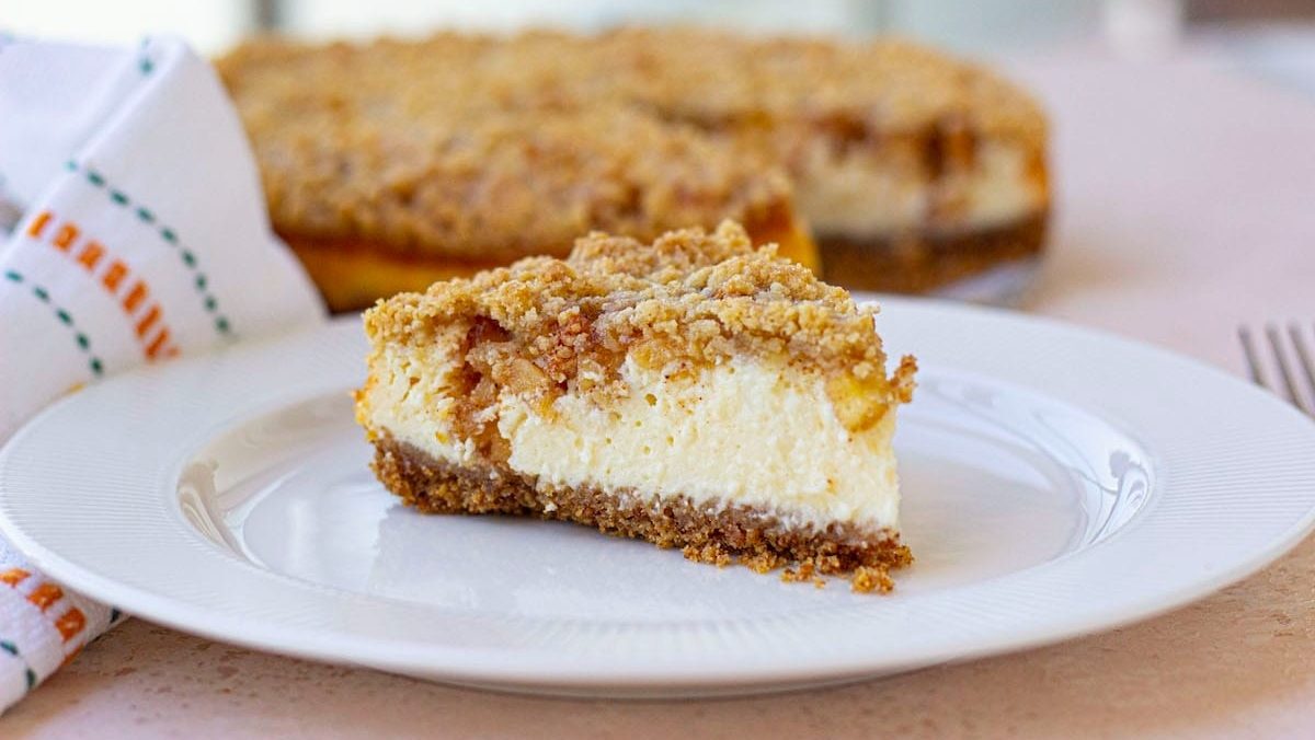 A slice of cheesecake on a plate with a napkin.