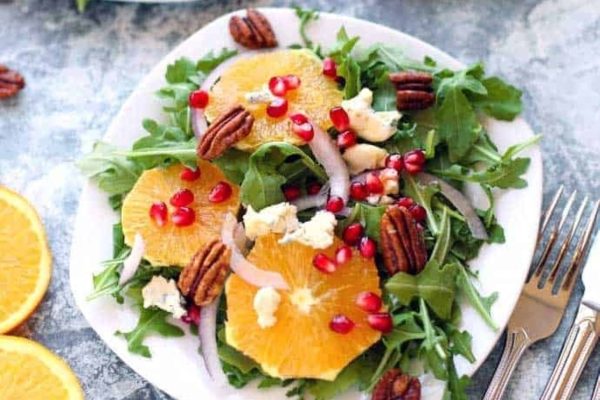 Refreshing Christmas salad with vibrant orange and pomegranate, tossed with peppery arugula and crunchy pecans.