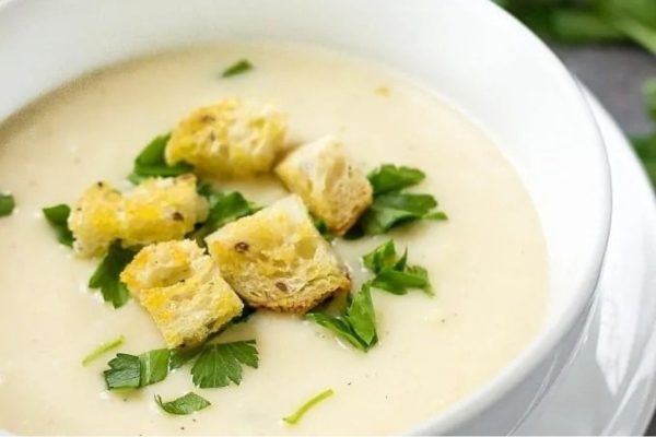 A few ingredient soup with croutons and parsley.