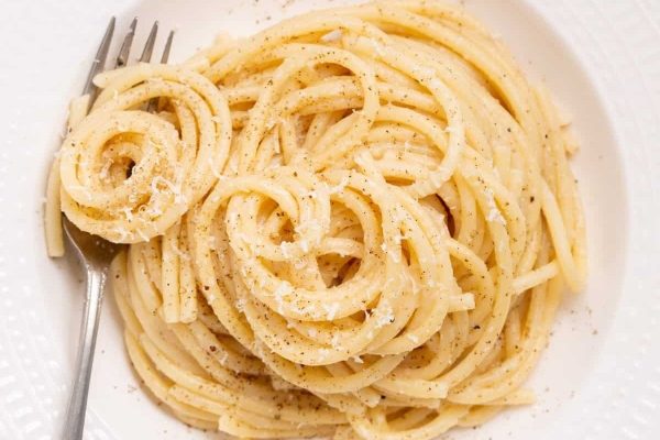 A love-filled plate of spaghetti with a fork on it, perfect for parents and kid-friendly recipes.