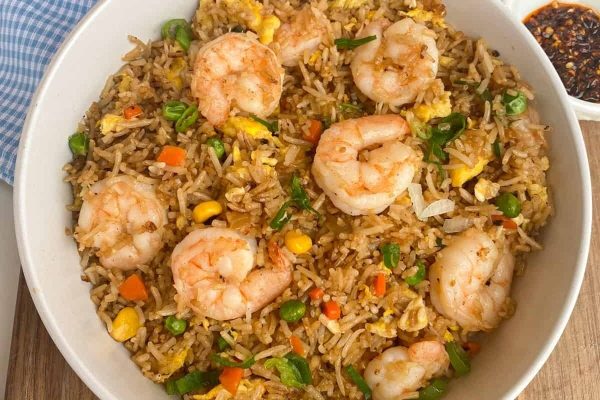 Budget friendly fried rice with shrimp and vegetables in a white bowl.