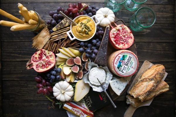 A Charcuterie cheese board with grapes, bread and cheese, perfect for Christmas gatherings.
