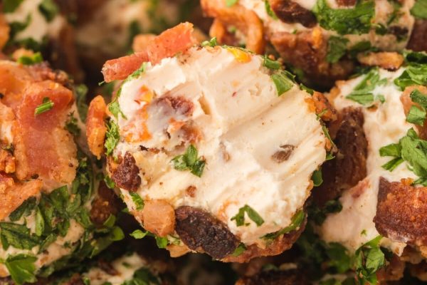 A close up of some meatballs with cheese.