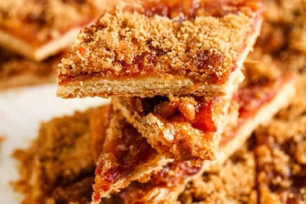 A stack of crumble bars on a white plate.