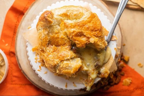 A brie and bacon pie on top of a plate.