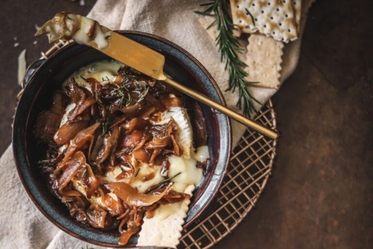 Festive appetizers for a Christmas party, featuring a bowl of cheese and crackers on a table.