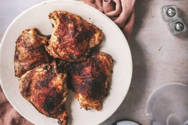 Roasted chicken breasts on a white plate.