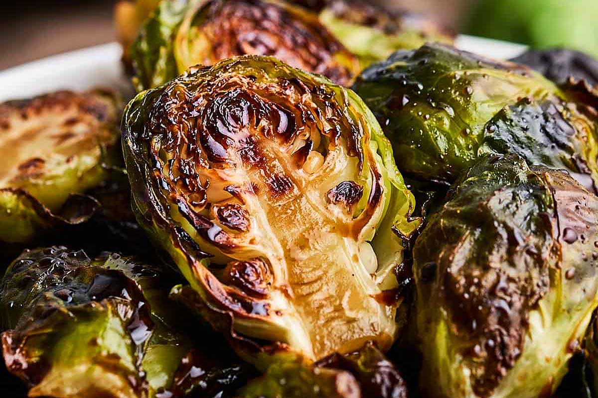 Roasted brussels sprouts in a white bowl.