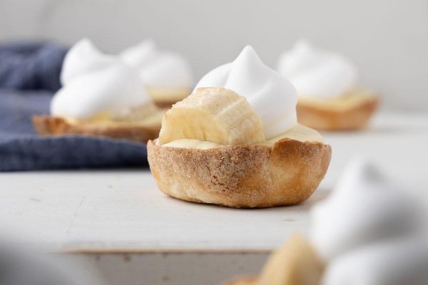 Banana creme brulee tarts with whipped cream.