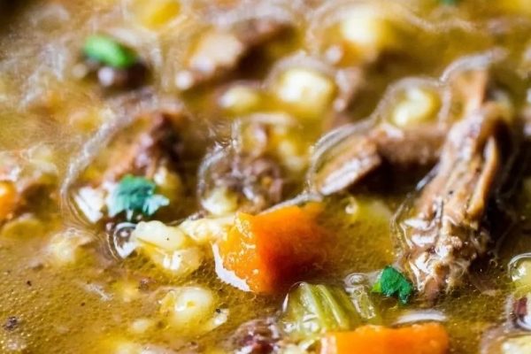 A classic bowl of beef stew with carrots and corn, reminiscent of 1950's comfort food.