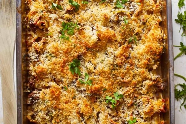A casserole dish with parmesan cheese and parsley.