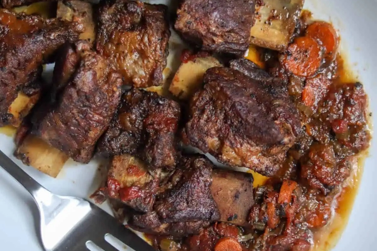 Country Style: A plate of hearty meat and vegetables with a fork that evokes the comforting taste of home. 
Thanksgiving Recipes: This plate includes a delicious mix of meat and vegetables that is perfect