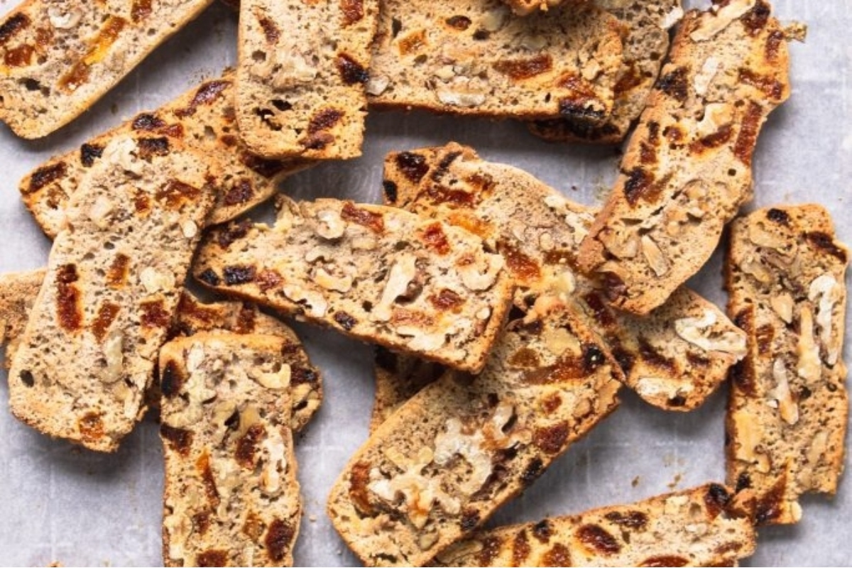 An Italian dessert featuring a pile of dried fruit and nuts on a piece of paper.