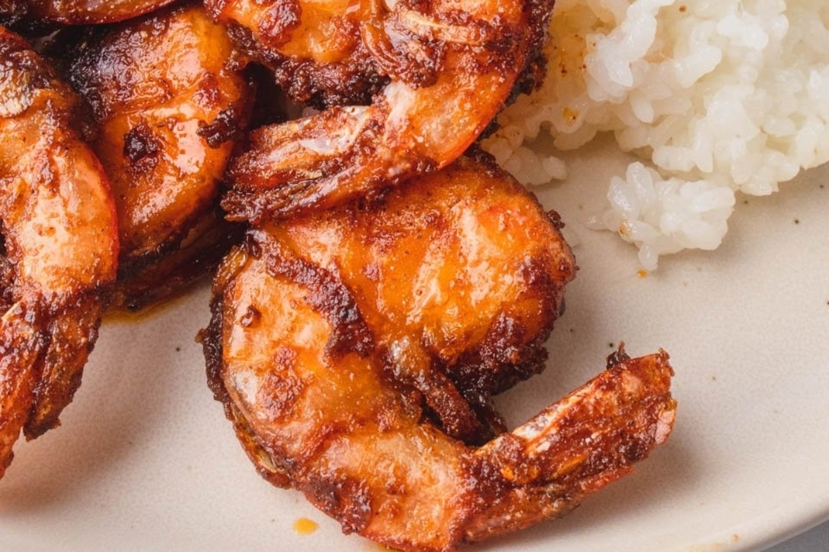 Hawaiian-inspired grilled shrimp on a plate with rice.