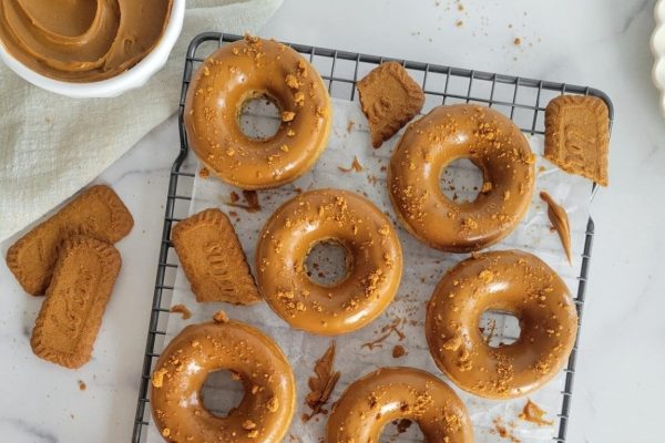 Peanut butter donuts on a cooling rack.