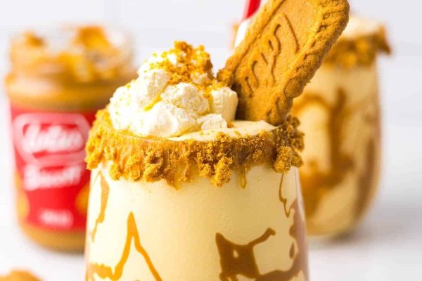 A delicious peanut butter milkshake recipe with whipped cream and a cookie garnish.