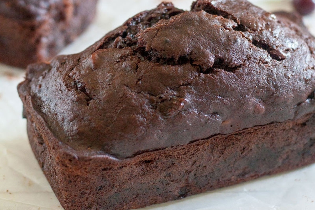 A loaf of edible chocolate banana bread is sitting on top of a piece of paper, making it the perfect gift for Christmas.
