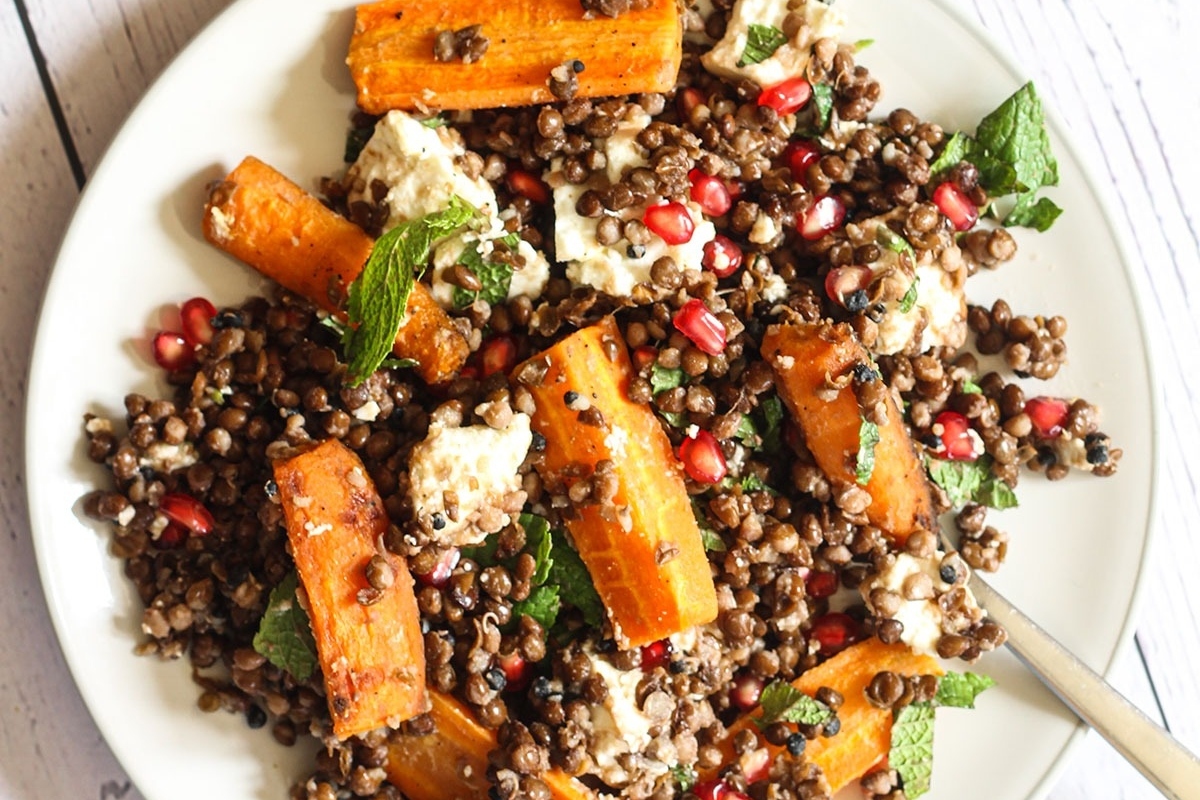 A plate of lentil salad with pomegranate and feta, perfect for pomegranate lovers looking for new recipes.