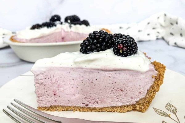 A slice of blackberry pie on a plate with a fork.