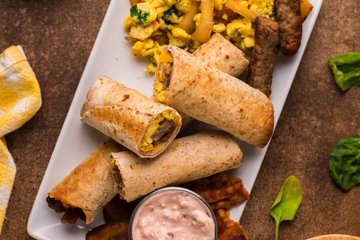 Breakfast burritos on a white plate.