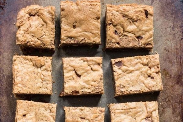 Chocolate chip cookie bars on a baking sheet.