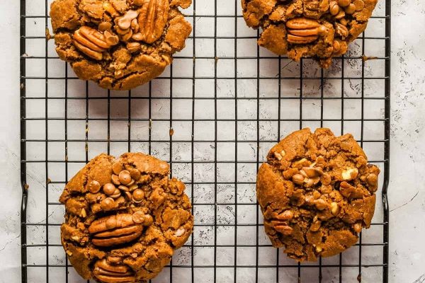 Pecan cookies on a cooling rack.