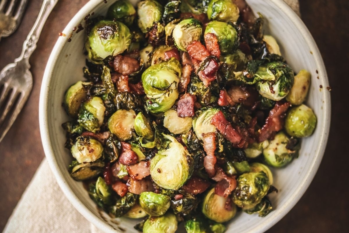 Country Style Brussels Sprouts with Bacon in a White Bowl Recipe for Thanksgiving.