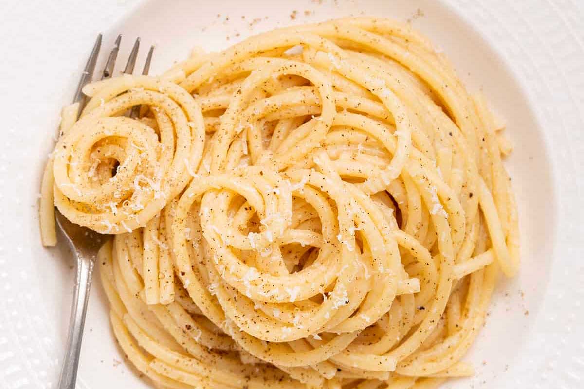 A romantic plate of spaghetti with a fork on it, perfect for a cozy date night.