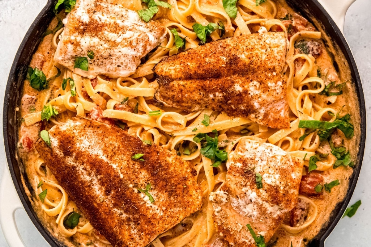 A skillet filled with pasta and chicken in a tomato sauce, perfect for quick and delicious dinners.