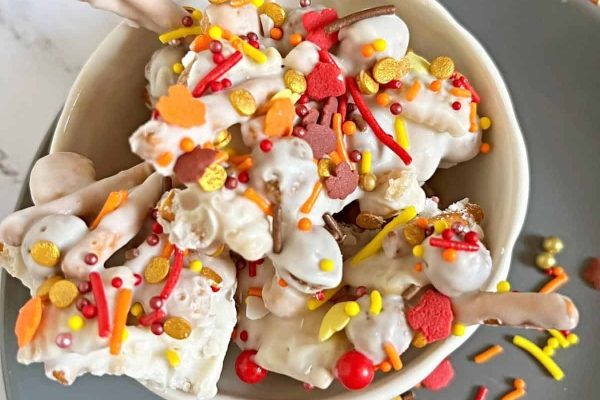 A cheap white bowl filled with candy and sprinkles.