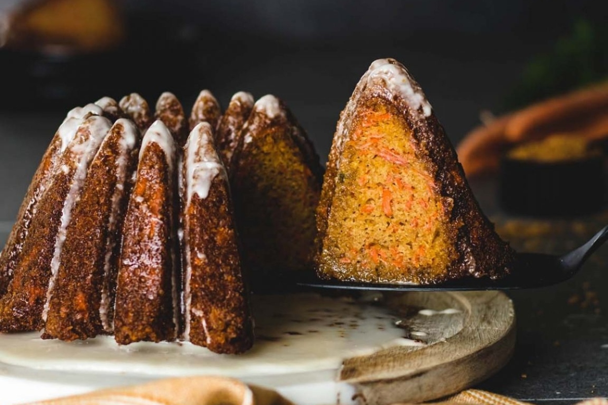 Carrot bundt cake with icing on a plate.