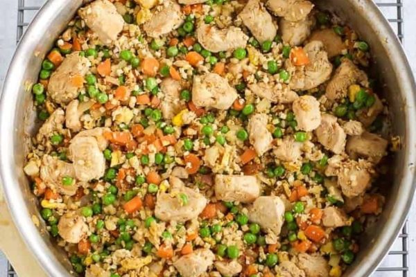 Chicken fried rice in a pan on a cooling rack.
