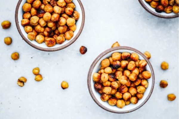 Roasted chickpeas in bowls on a white background perfect for a potluck or Thanksgiving.