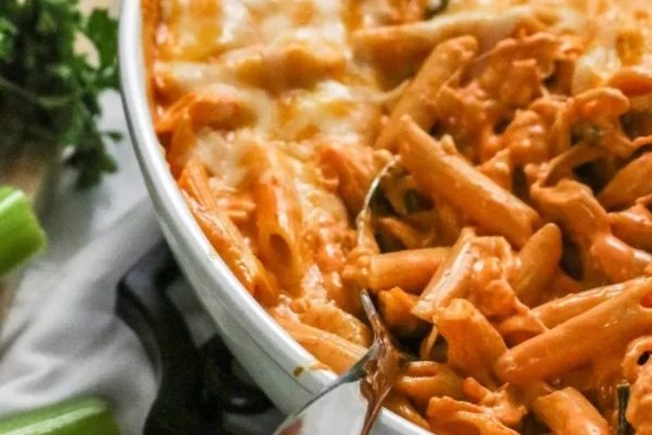 An Italian main dish consisting of a bowl of pasta with chicken and cheese.