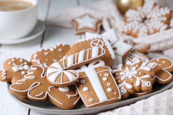 Gingerbread cookies on a plate with a cup of coffee.