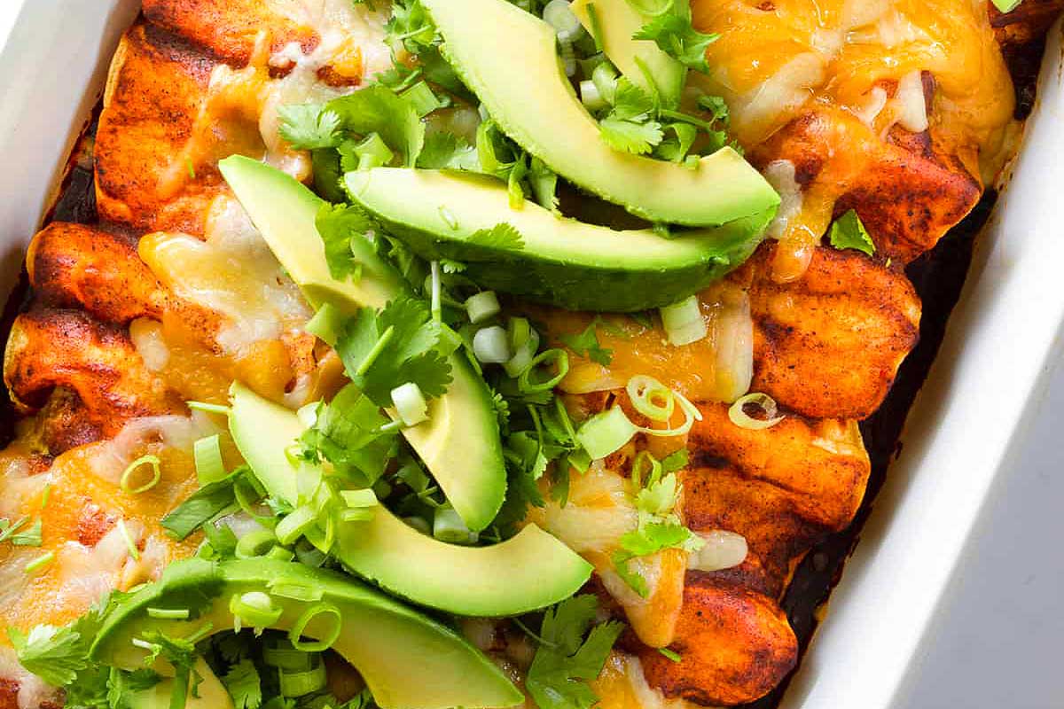 Mexican enchiladas in a white baking dish.