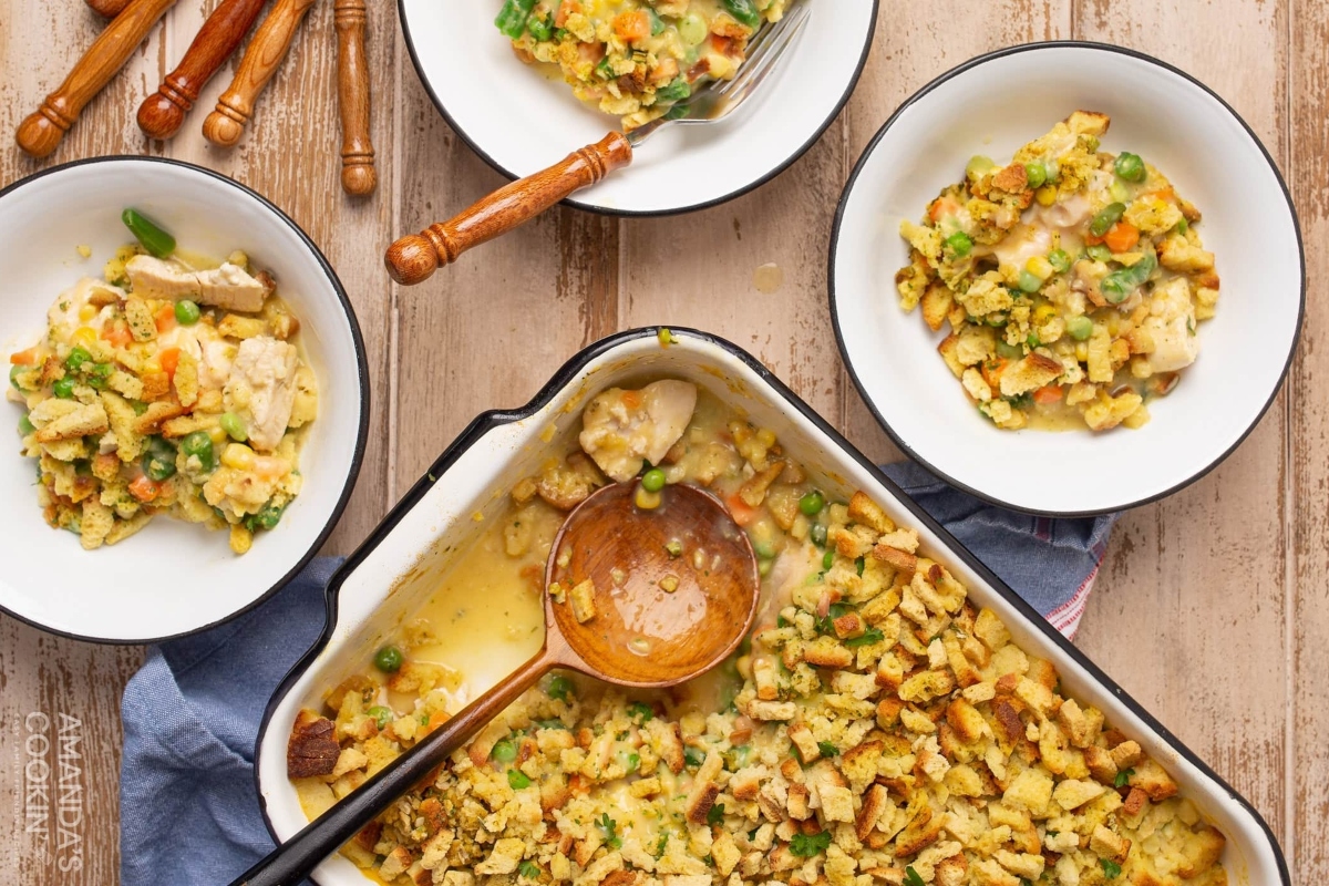 A delicious casserole dish combining chicken, cranberries, and frozen mixed vegetables, served on a rustic wooden table. This recipe is perfect for any occasion and will surely impress your guests.