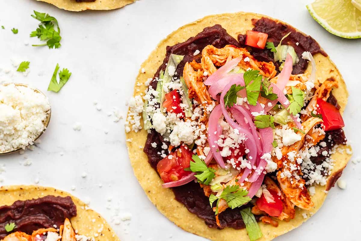 Mexican chicken tacos on a marble countertop.