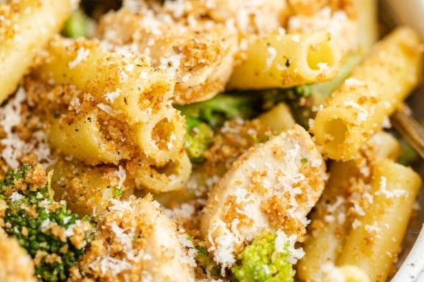 Chicken and broccoli pasta in a white bowl.