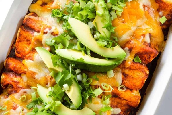 Mexican enchiladas in a white baking dish.