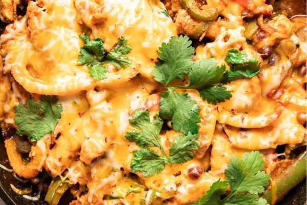 Chicken enchilada casserole in a skillet.