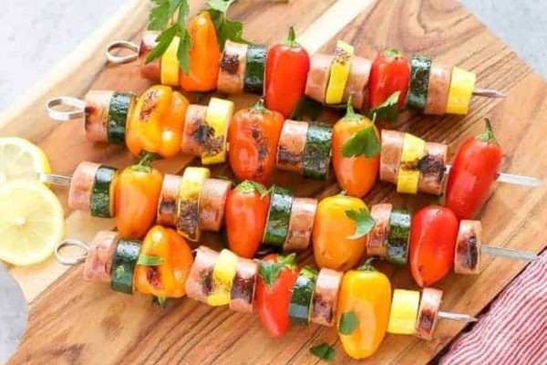 Kid Friendly grilled vegetables on skewers on a wooden cutting board.