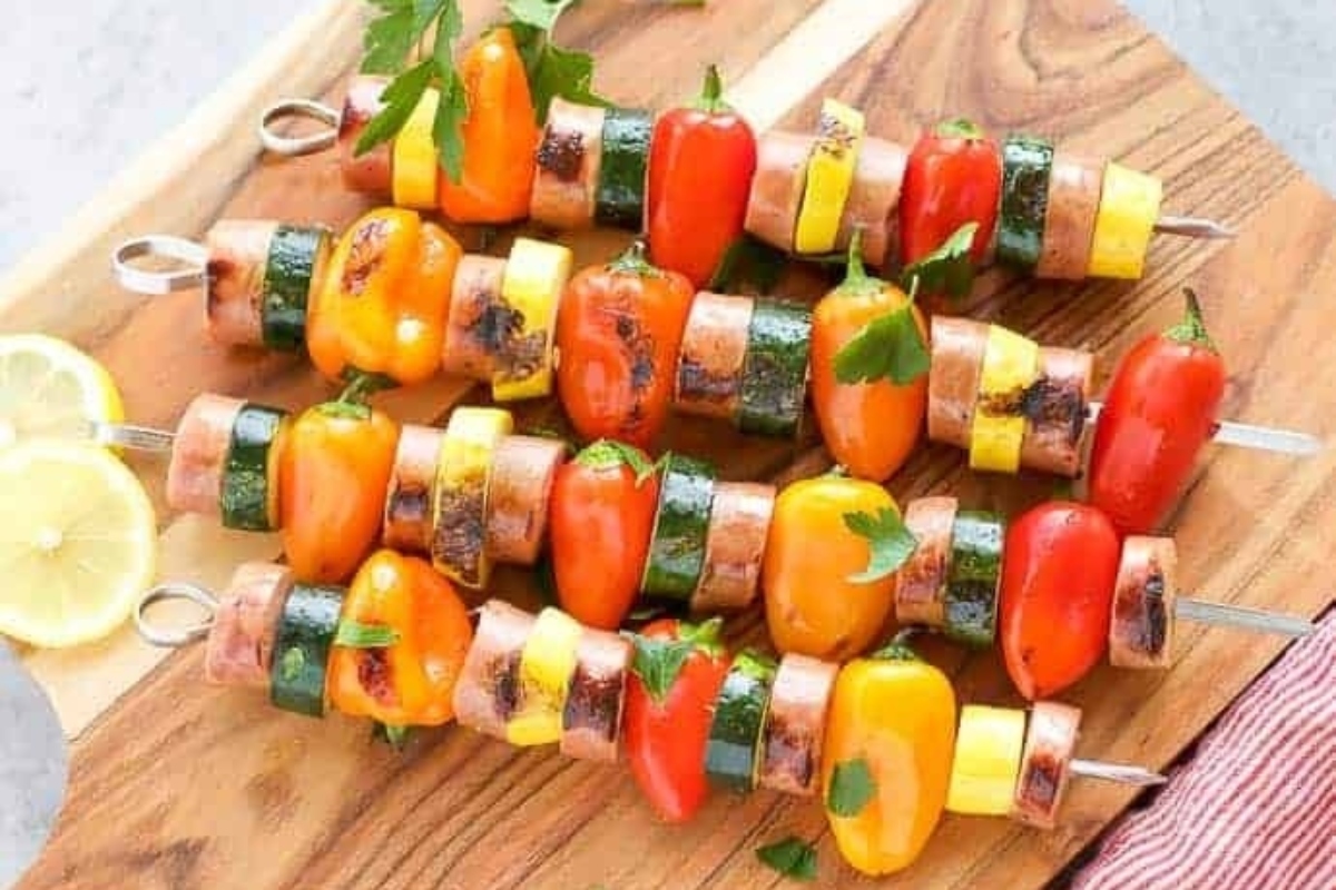 Kid Friendly grilled vegetables on skewers on a wooden cutting board.